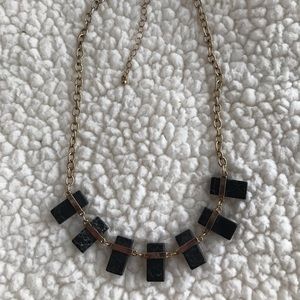 Gold tone necklace with black stones